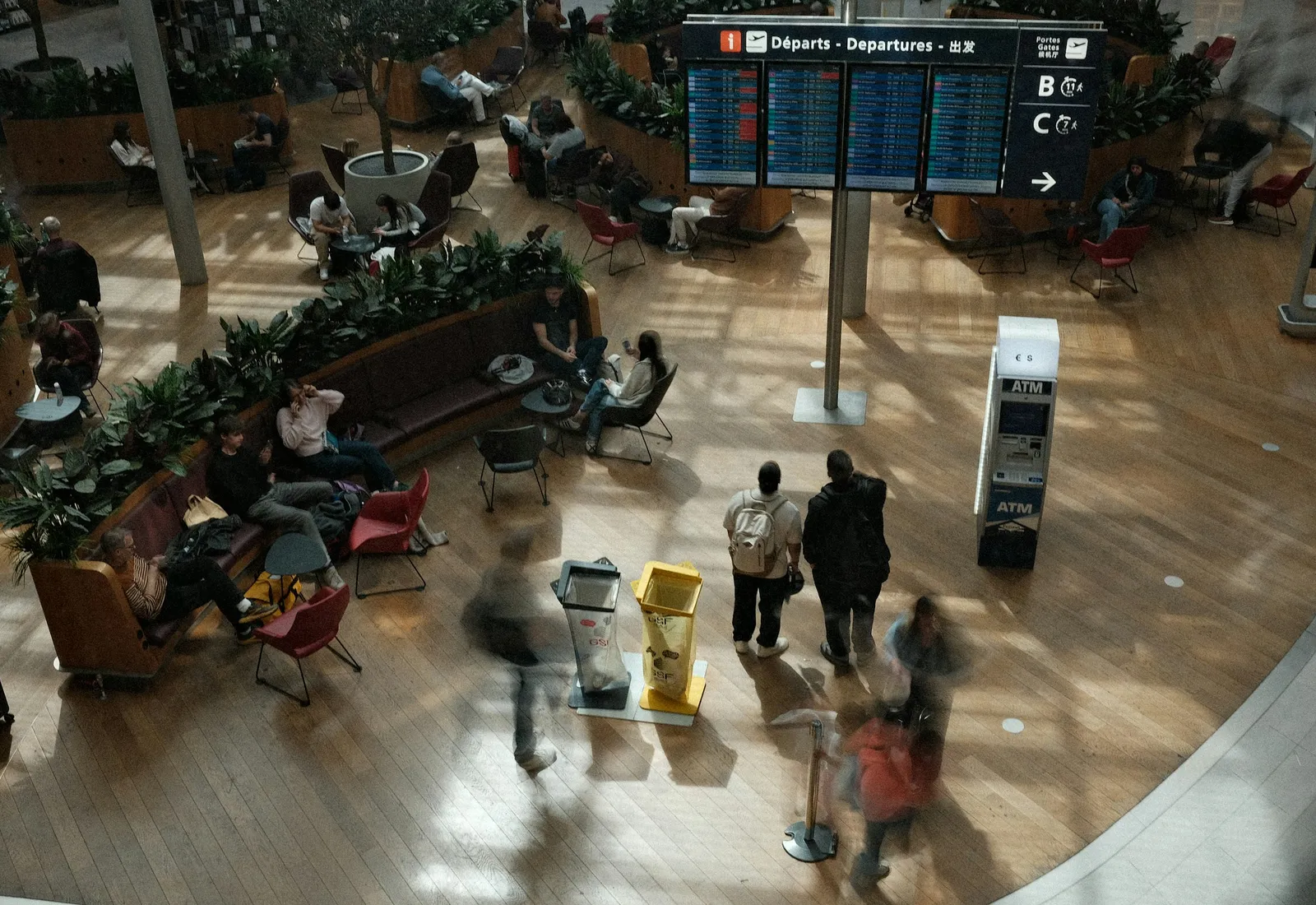 Travellers moving through an airport departures hall